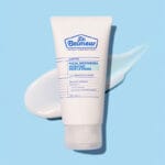 Dr. Belmeur Clarifying Facial Moisturizer 120ml - light moisturizer for acne-prone skin with niacinamide and panthenol. Image of product with cream in the background. 